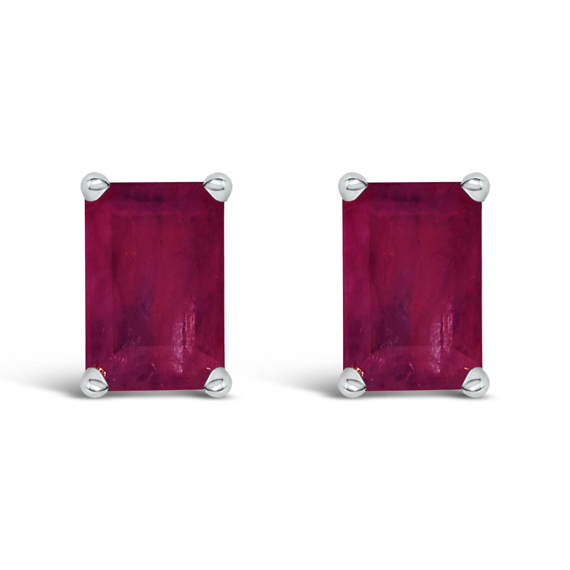 Front view of a pair of rectangular red gemstone earrings set in white metal with four-prong settings.