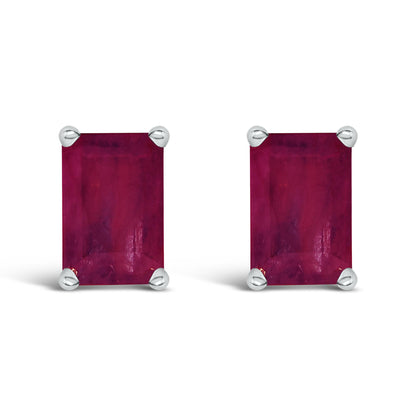 Front view of a pair of rectangular red gemstone earrings set in white metal with four-prong settings.