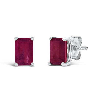 Close-up front and side view of white metal stud earrings with rectangular red gemstones in four-prong settings.
