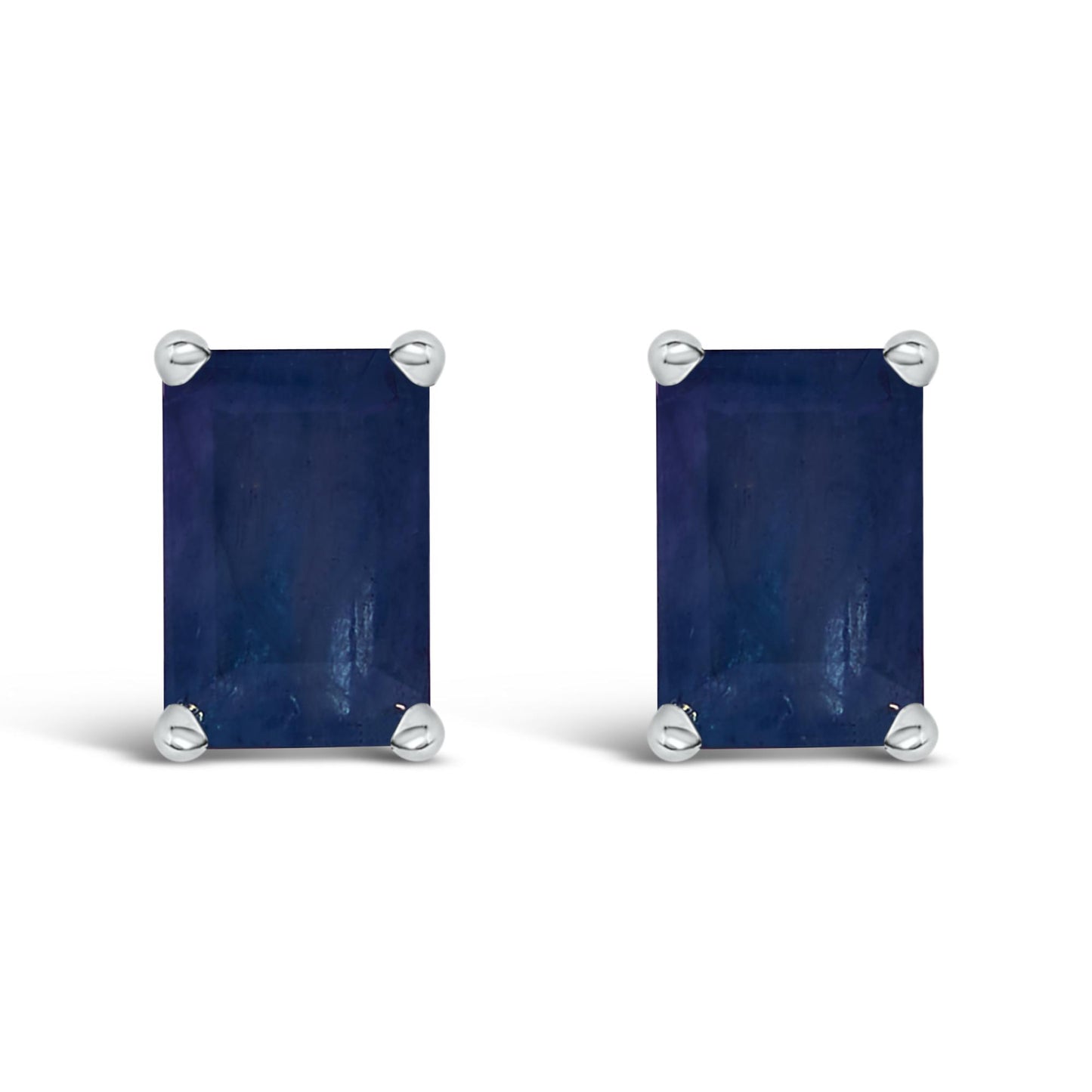 Front-facing pair of white metal earrings with emerald-shaped blue gemstones in a four-prong setting.