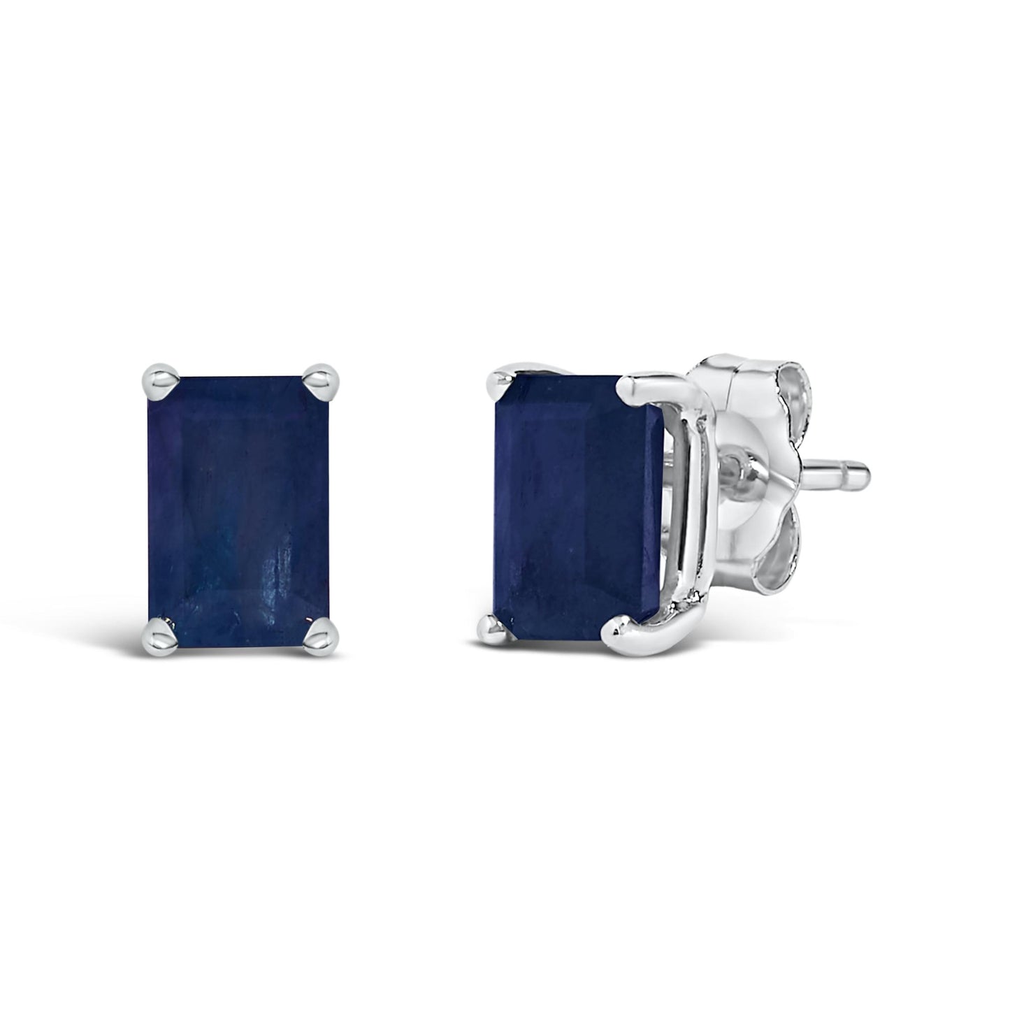 Pair of white metal stud earrings with blue emerald-shaped gemstones in a 4-prong setting, shown from front and side angles on a white background.