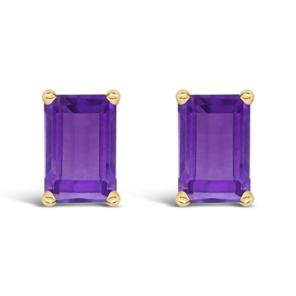 Close-up front view of a pair of yellow metal stud earrings featuring rectangular purple gemstones set with four prongs.