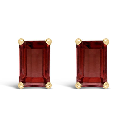 Pair of yellow metal stud earrings with rectangular red gemstones in four-prong settings, shown from the front on a white background.