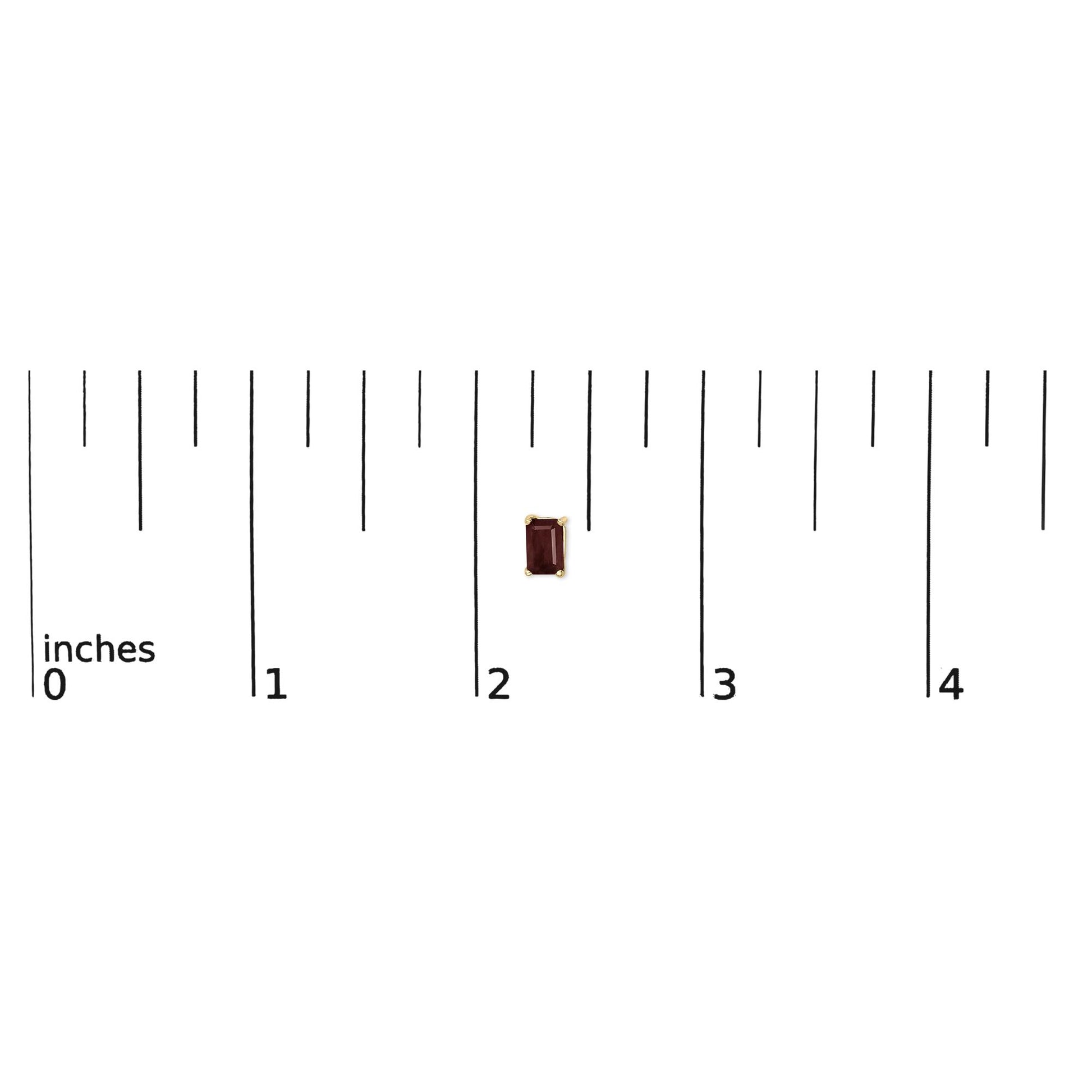 Single yellow metal earring with a red rectangular gemstone in a four-prong setting shown on a ruler scale from a top-down angle.