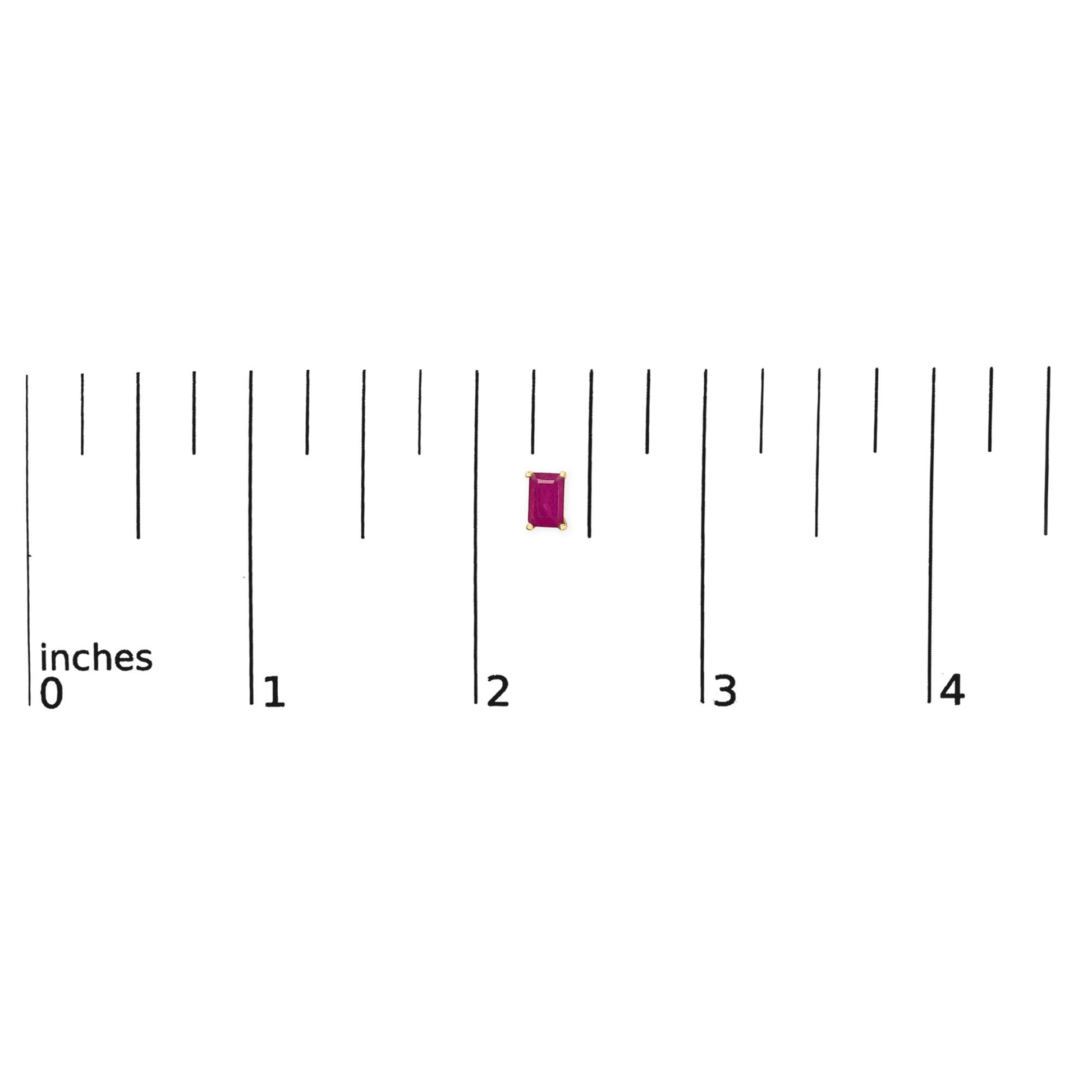 Close-up shot of a single yellow metal earring with a rectangular red gemstone in a four-prong setting, shown on a ruler scale.