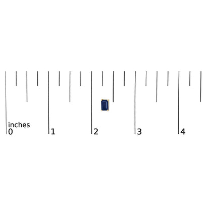 Single yellow metal earring with a blue emerald-shaped gemstone in a 4-prong setting shown on a scale, front view.