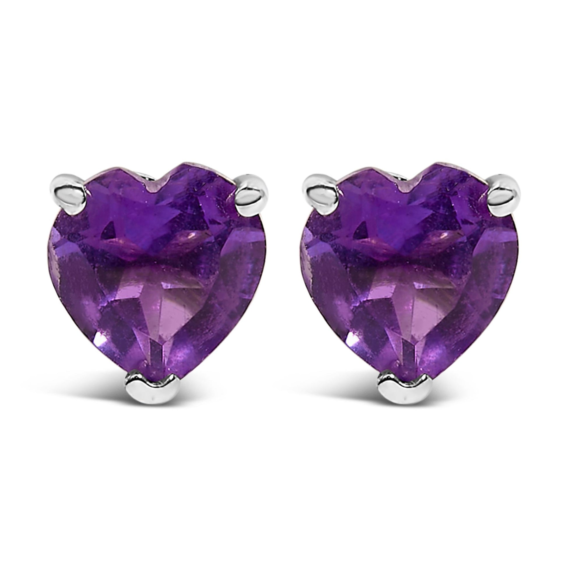 Pair of white metal stud earrings with purple heart-shaped gemstones in a 3-prong setting, shown from a front angle.