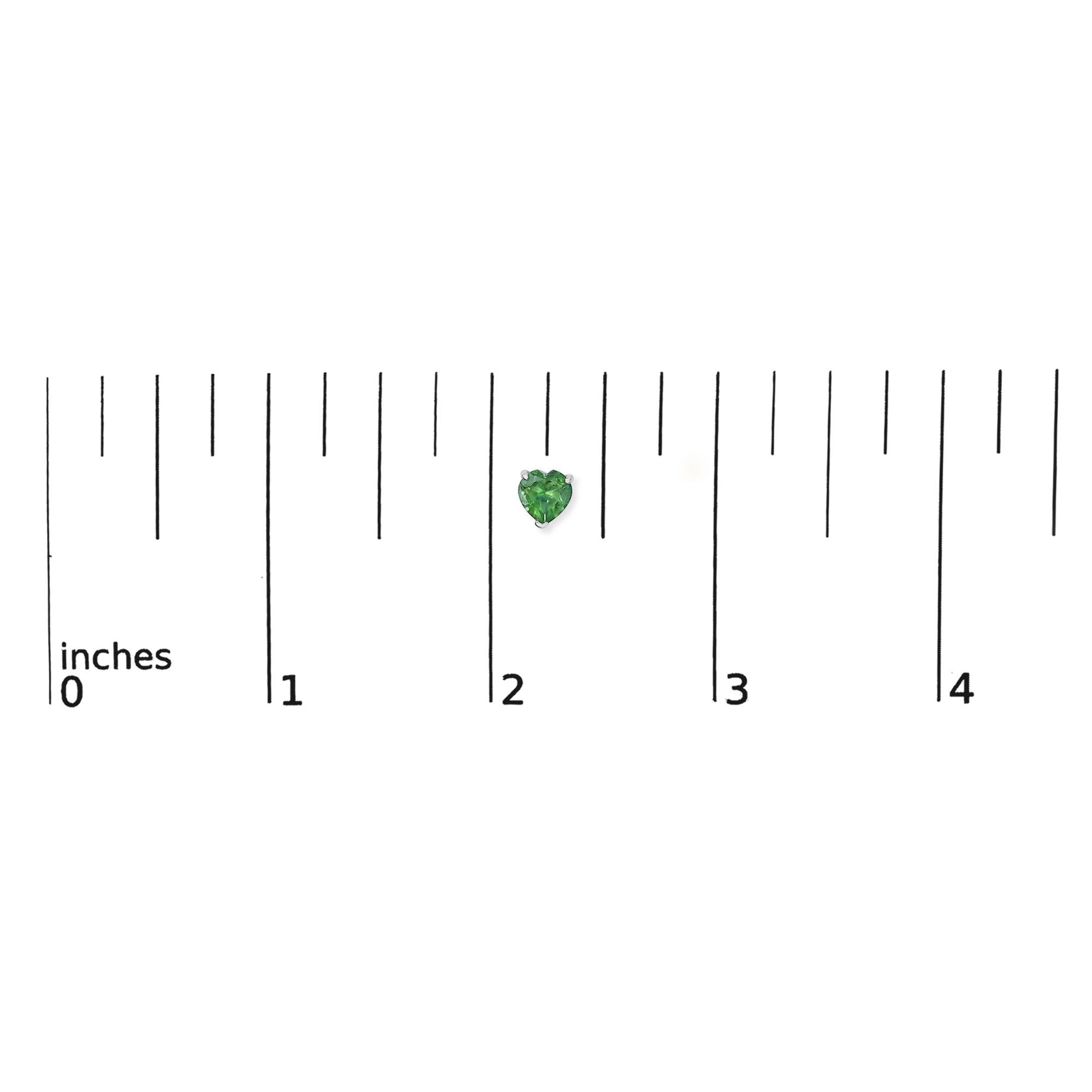 Alt text: Single white metal earring with heart-shaped green gemstones in 3-prong setting, shown on a ruler scale from a top-down angle.