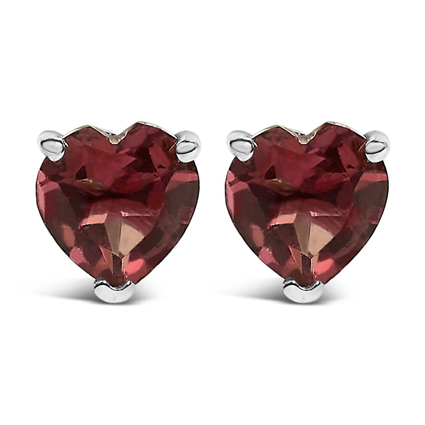 Pair of white metal stud earrings with heart-shaped red gemstones in three-prong settings, shown from the front angle.