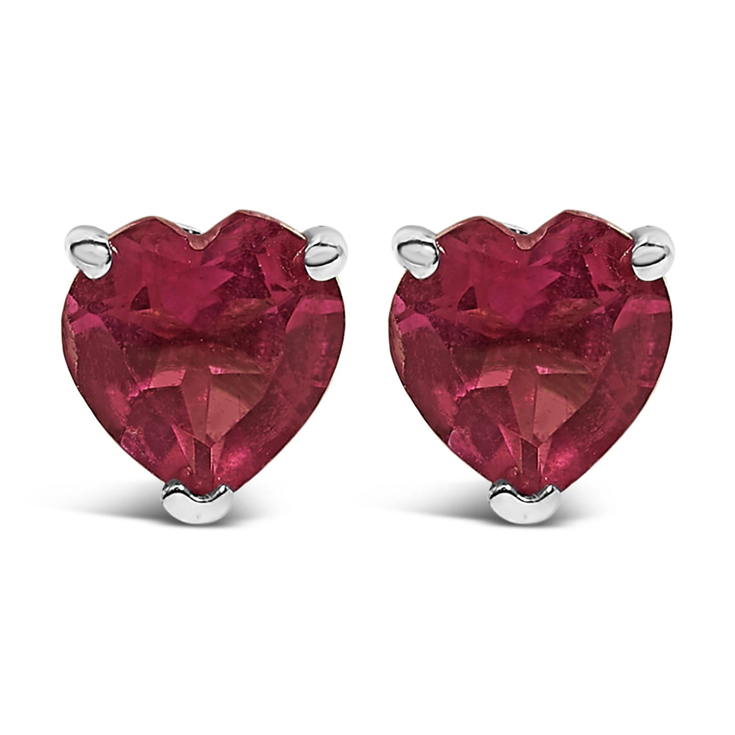 Front view of a pair of white metal stud earrings featuring heart-shaped red gemstones in 3-prong settings.