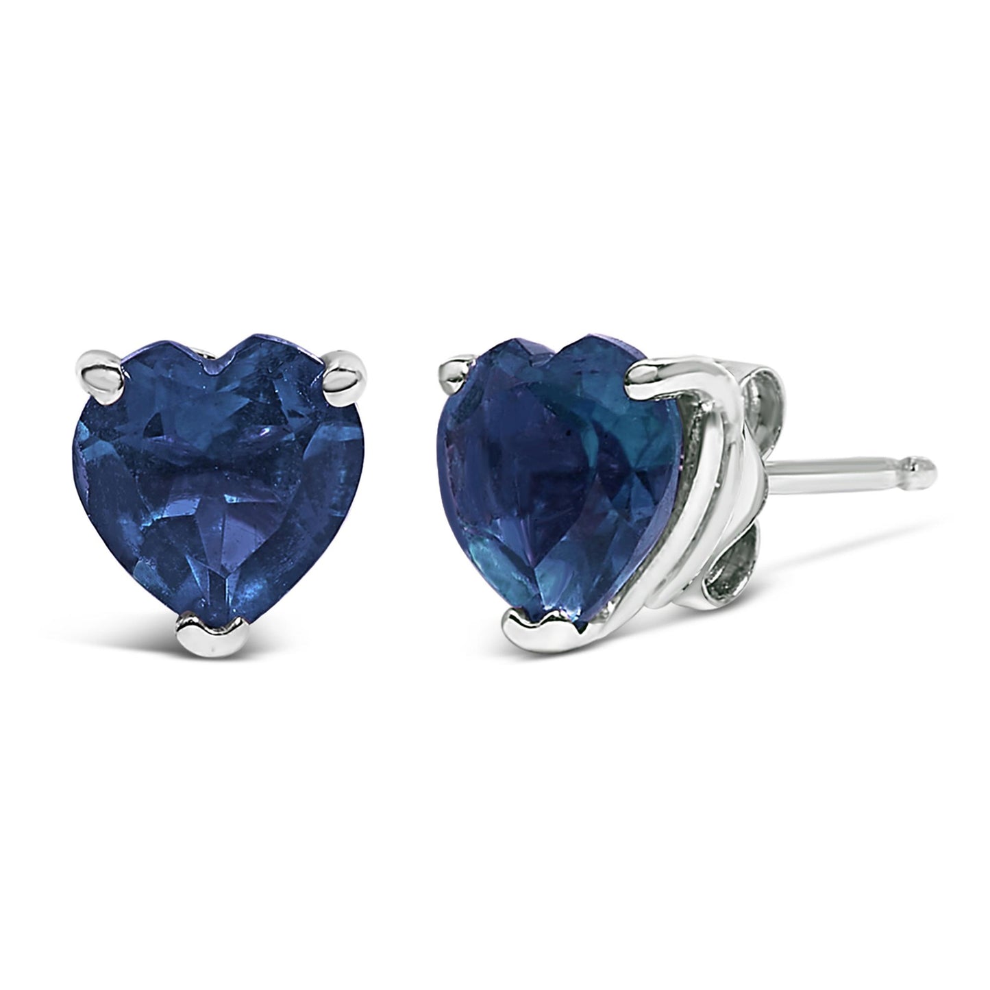 Pair of white metal stud earrings with heart-shaped blue gemstones set in three prongs, shown in a close-up front and side angle.