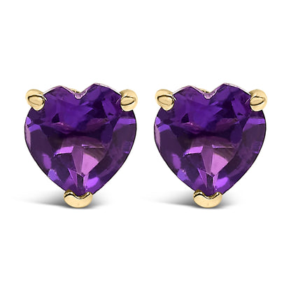 Pair of yellow metal stud earrings with heart-shaped purple gemstones, shown from the front angle.