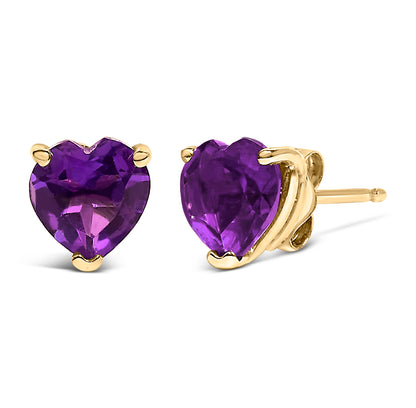 Close-up front and side view of yellow metal earrings featuring heart-shaped purple gemstones in a three-prong setting.