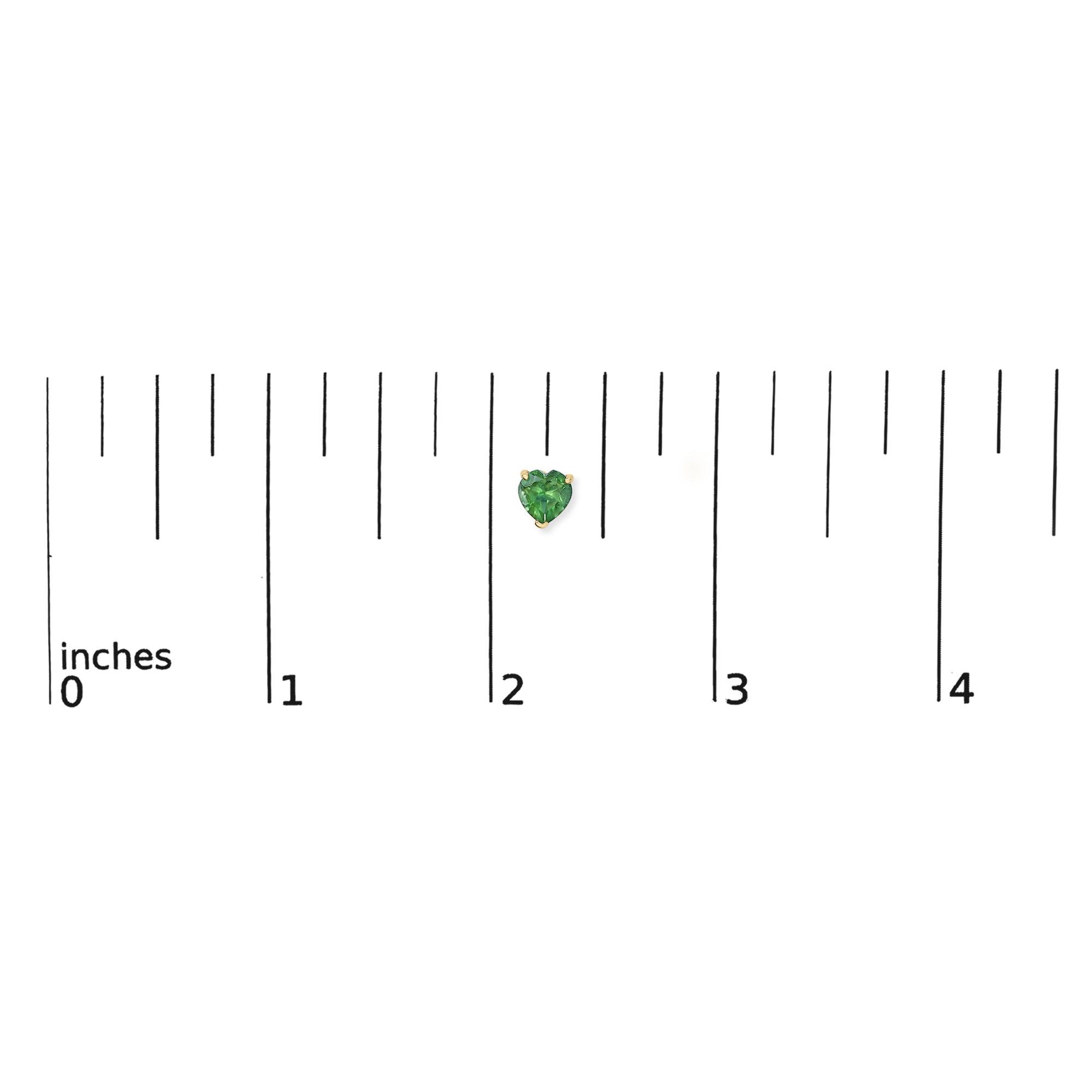 Single yellow metal earring with heart-shaped green gemstone in 3-prong setting shown on a ruler scale from front angle.