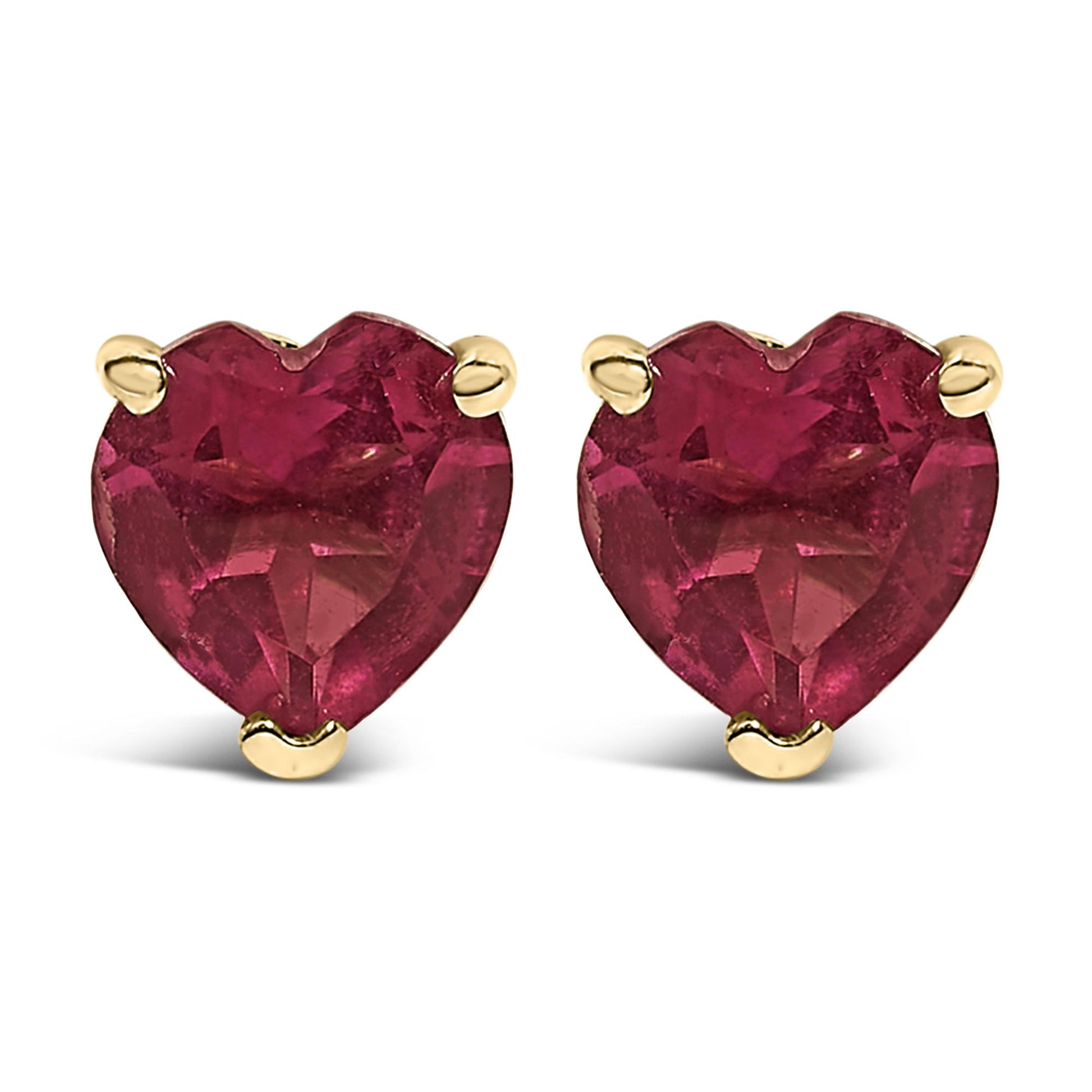 Close-up front view of a pair of yellow metal earrings with heart-shaped red gemstones in a three-prong setting.