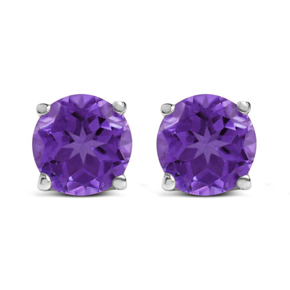 Front view of round purple gemstone stud earrings set in white metal with four-prong settings.