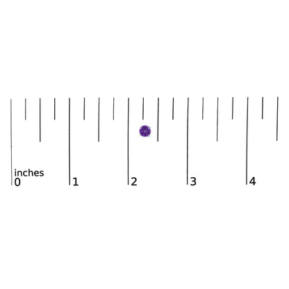 White metal stud earrings with round purple gemstones in four-prong settings shown on a ruler scale from a top view.