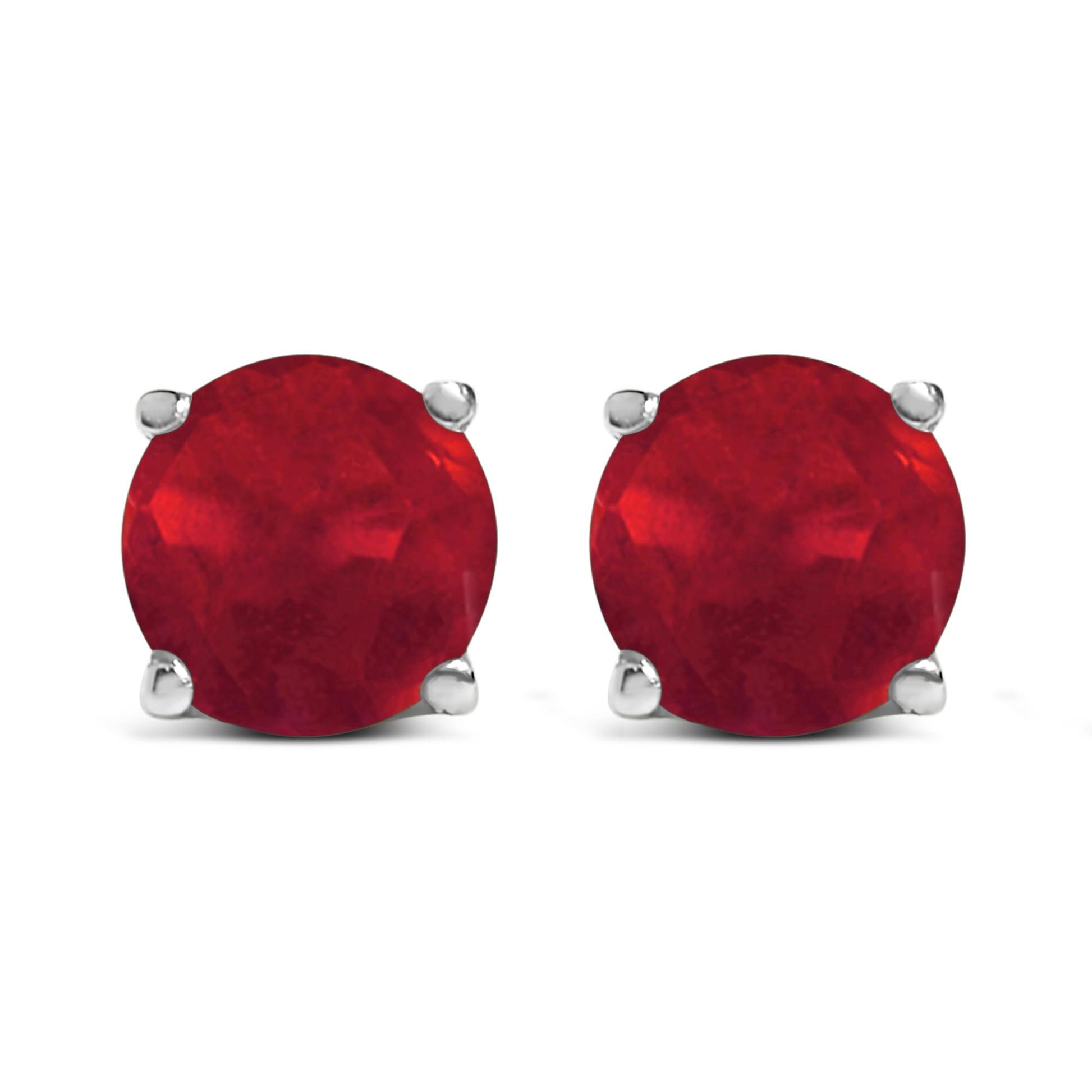 Front view of white metal stud earrings with round red gemstones in a four-prong setting.