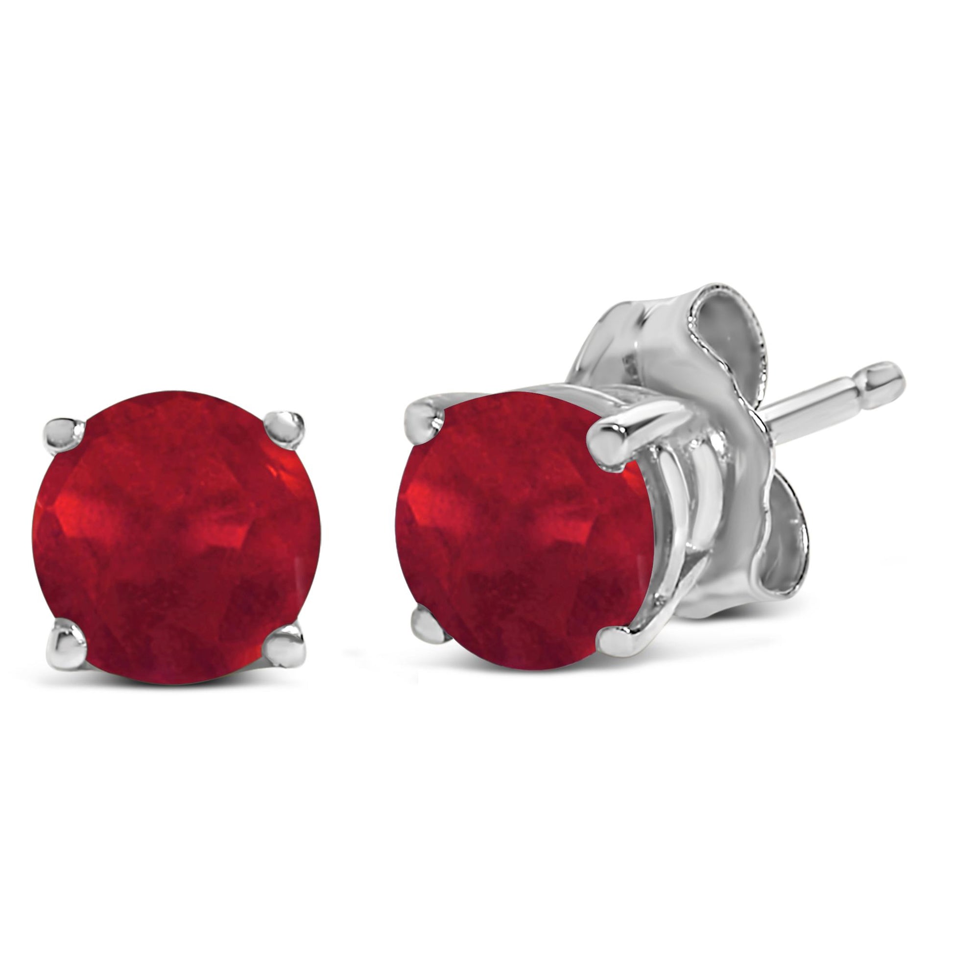 Pair of white metal stud earrings with round red gemstones in a 4-prong setting, shown in a close-up angled view.