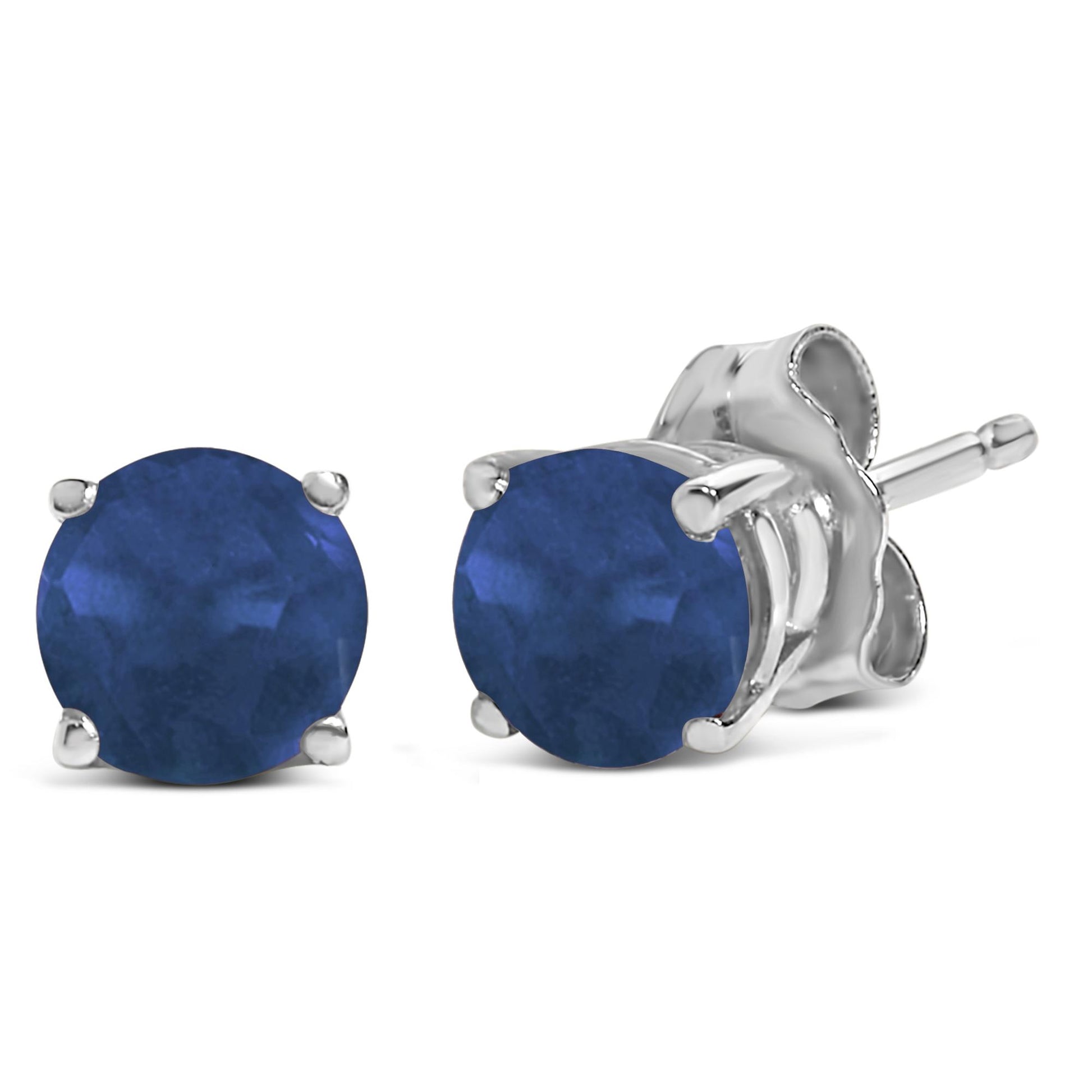 Pair of white metal stud earrings with round blue gemstones in four-prong settings, shown from a front and side angle on a white background.