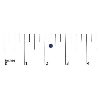 Close-up front view of a single round blue gemstone earring in a four-prong white metal setting, shown on a scale.