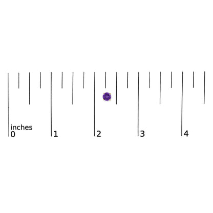 Close-up top view of a single round purple gemstone stud earring set in yellow metal 4-prong setting, shown on a measurement scale.