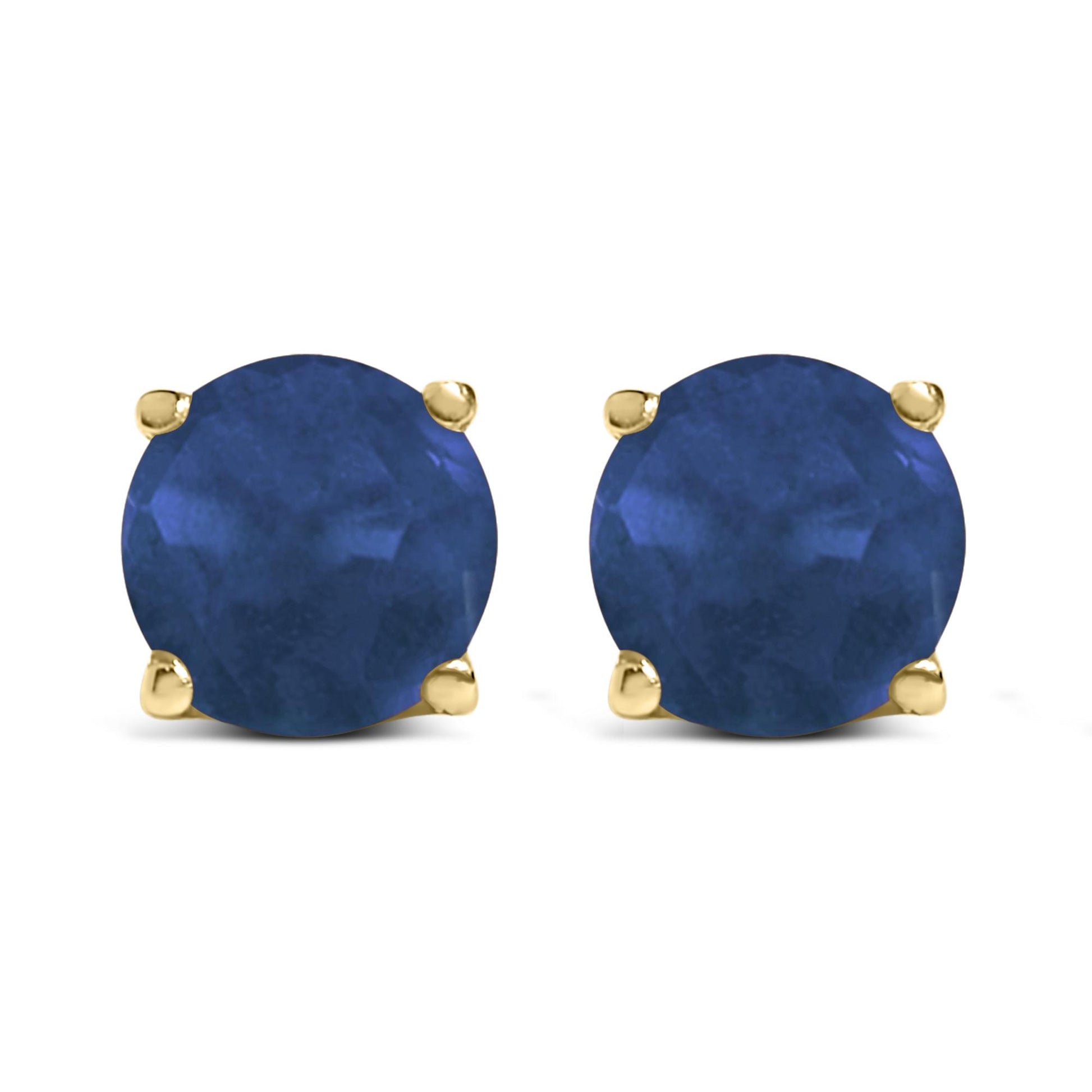 Front view of yellow metal stud earrings with round blue gemstones in four-prong settings.