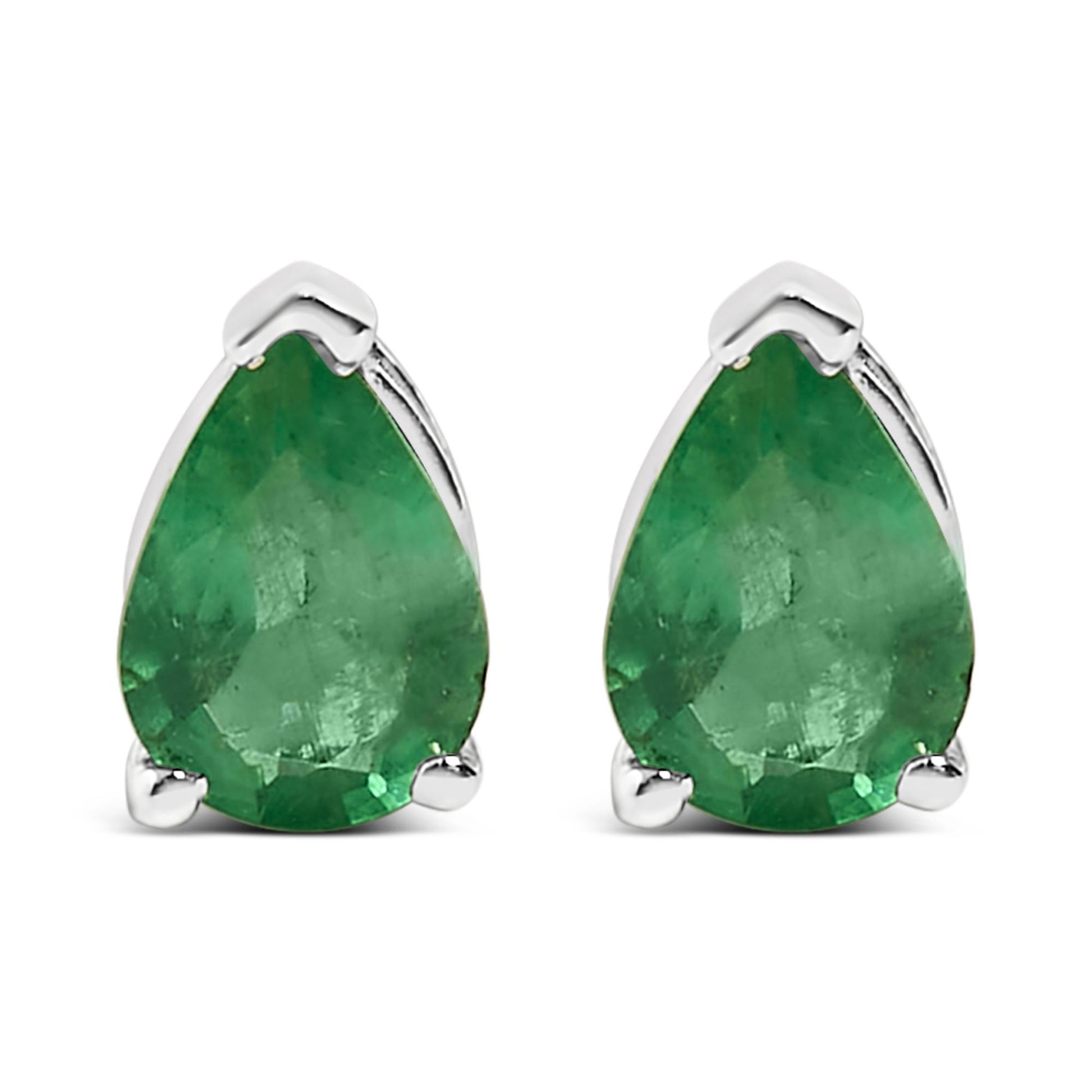 Front view of white metal earrings with pear-shaped green gemstone in three-prong setting, shown on a white background.