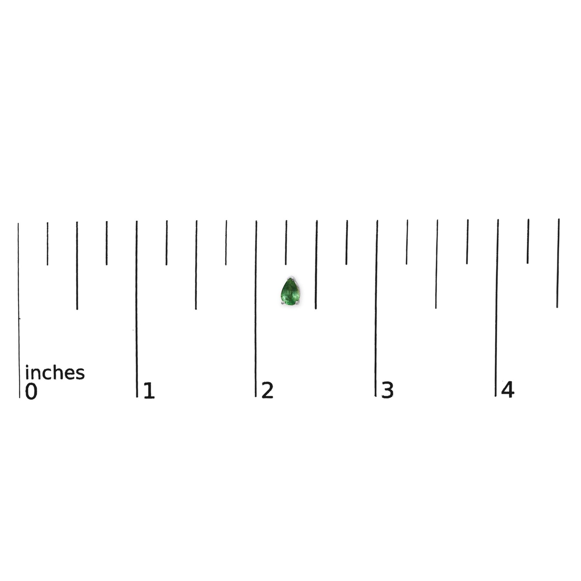 Close-up front view of a white metal pear-shaped green gemstone earring shown on a ruler scale.