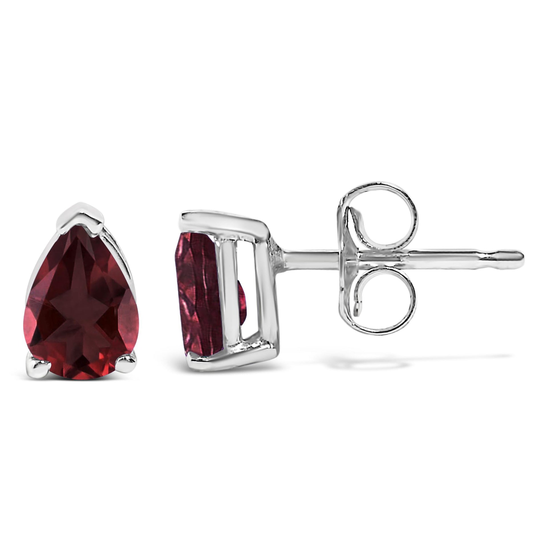Close-up front and side view of a pair of white metal stud earrings with pear-shaped red gemstones in three-prong settings.