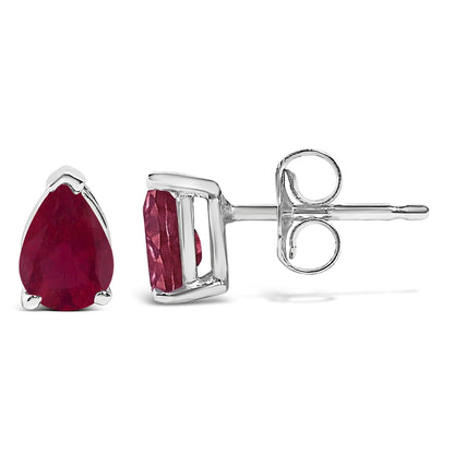 Pair of white metal stud earrings with pear-shaped red gemstones in a 3-prong setting, shown from front and side angles on a white background.