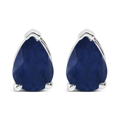 Front view of white metal earrings with pear-shaped blue gemstones in three-prong settings.