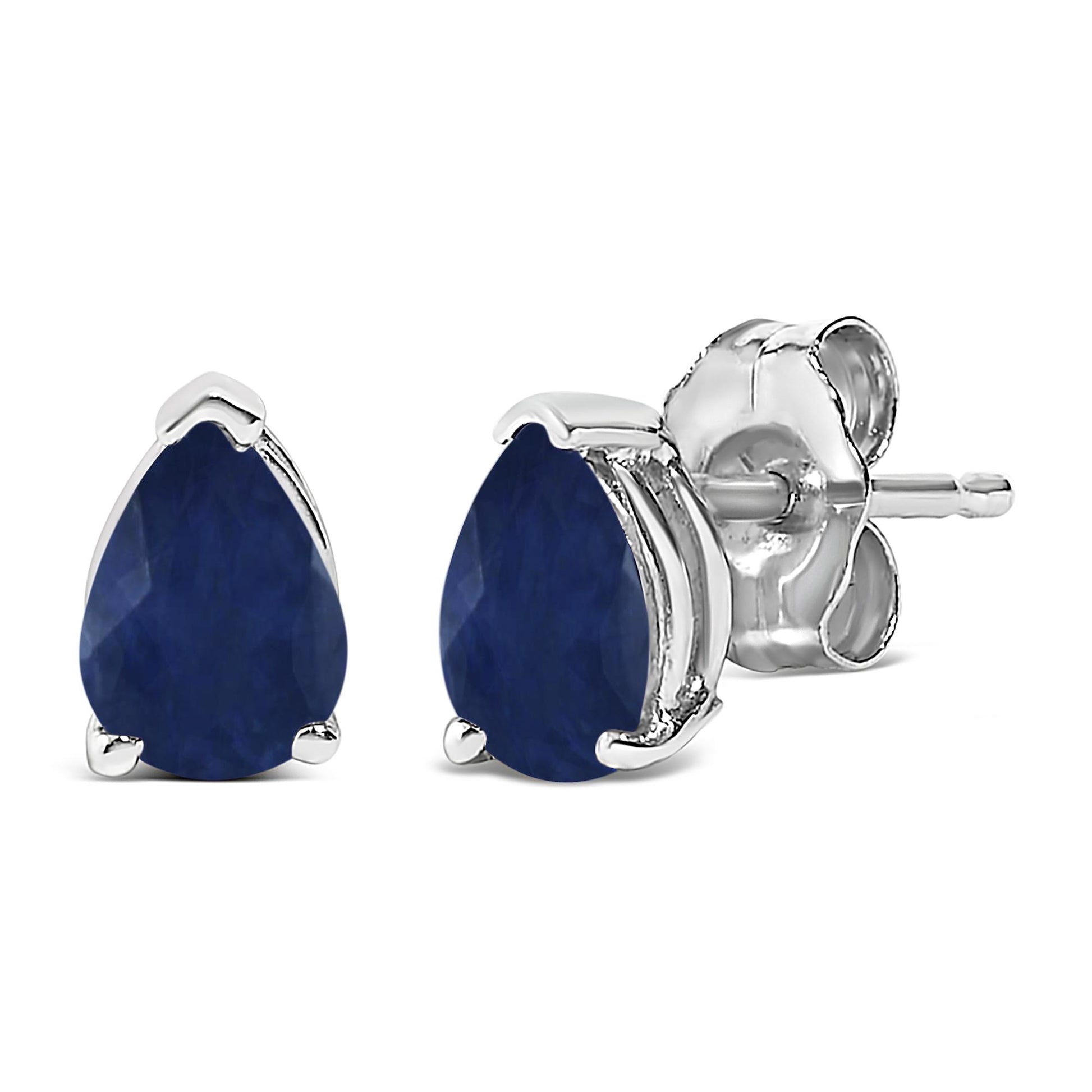 Close-up front and side angled view of a pair of white metal stud earrings, each with a pear-shaped blue gemstone secured by a three-prong setting.