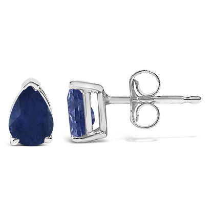 Pair of white metal stud earrings with pear-shaped blue gemstones in three-prong settings, shown from front and side angles on a white background.