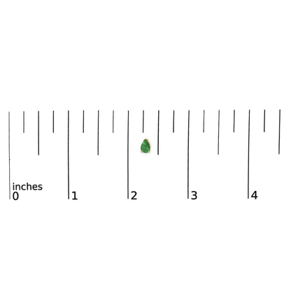 Close-up front view of a single yellow metal earring with a pear-shaped green gemstone in a three-prong setting, shown on a ruler scale.