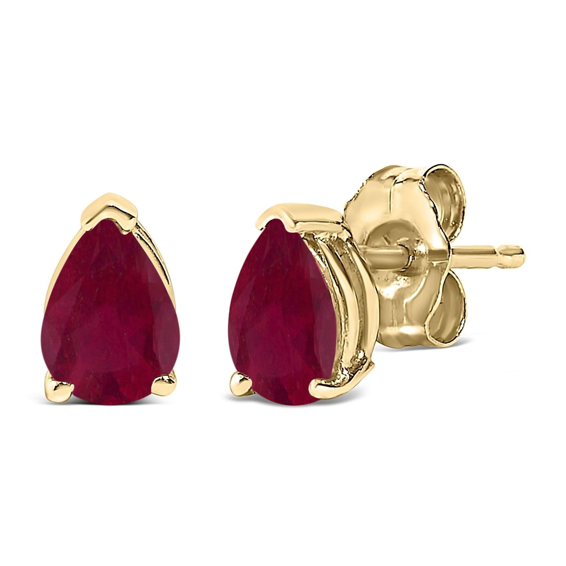 Close-up front and side view of yellow metal stud earrings with pear-shaped red gemstones in 3-prong settings.