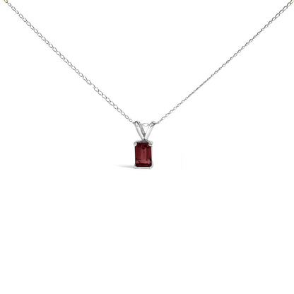 Front view of a white metal necklace with a rectangular red gemstone pendant set in a four-prong setting.