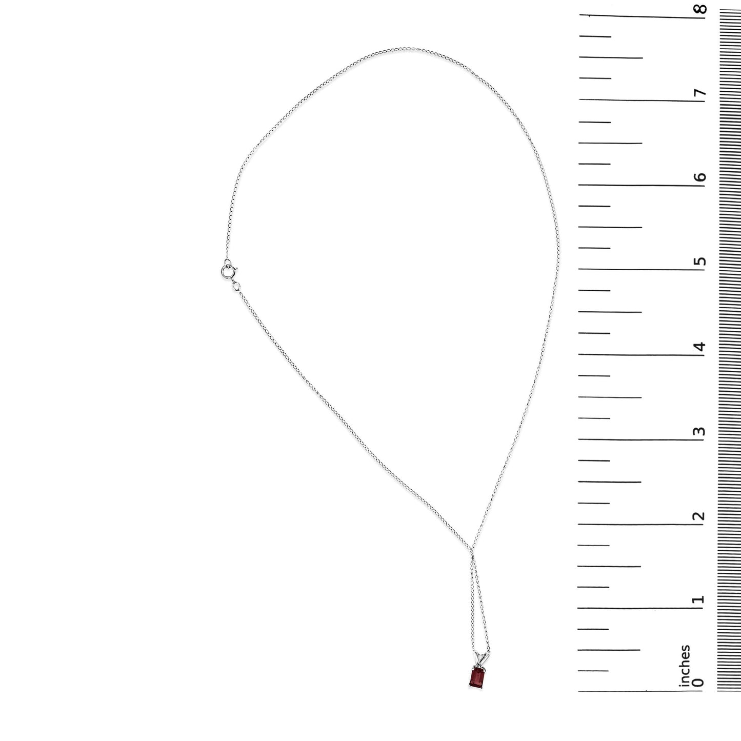 White metal necklace with a single emerald-shaped red gemstone pendant in a 4-prong setting, shown flat on a scale, top-down view.