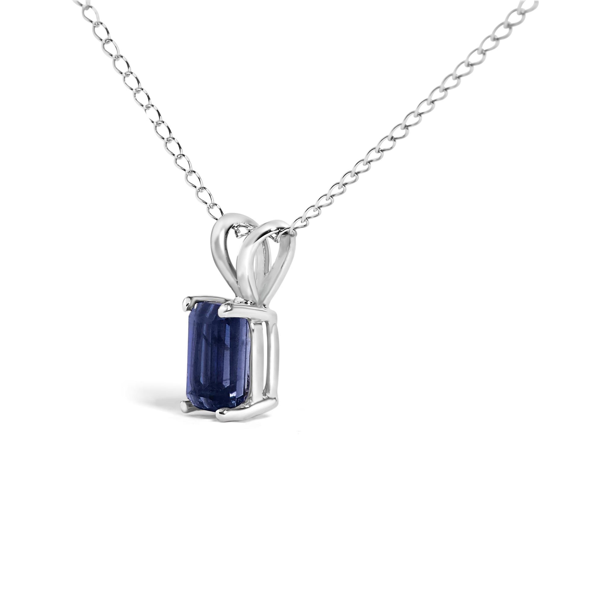 Close-up front angle of a white metal necklace with a rectangular blue gemstone in a four-prong setting.