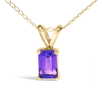 Close-up front view of a yellow metal necklace with a rectangular purple gemstone in a four-prong setting.