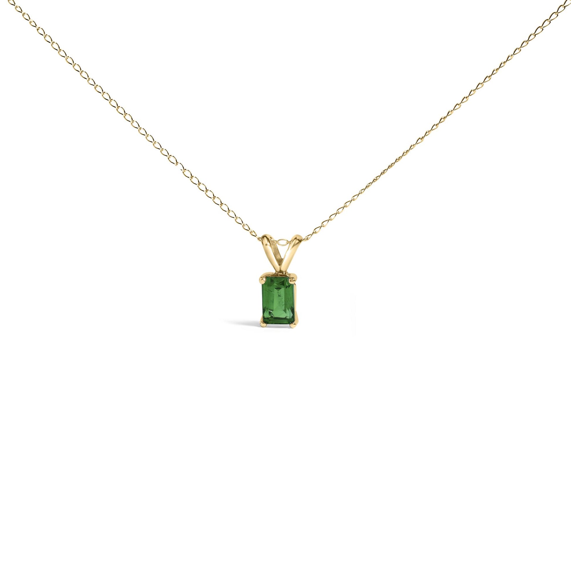 Front view of a yellow necklace with a rectangular green gemstone pendant held by four prongs.