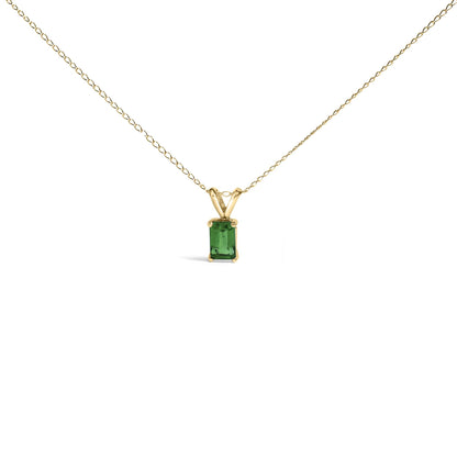 Front view of a yellow necklace with a rectangular green gemstone pendant held by four prongs.