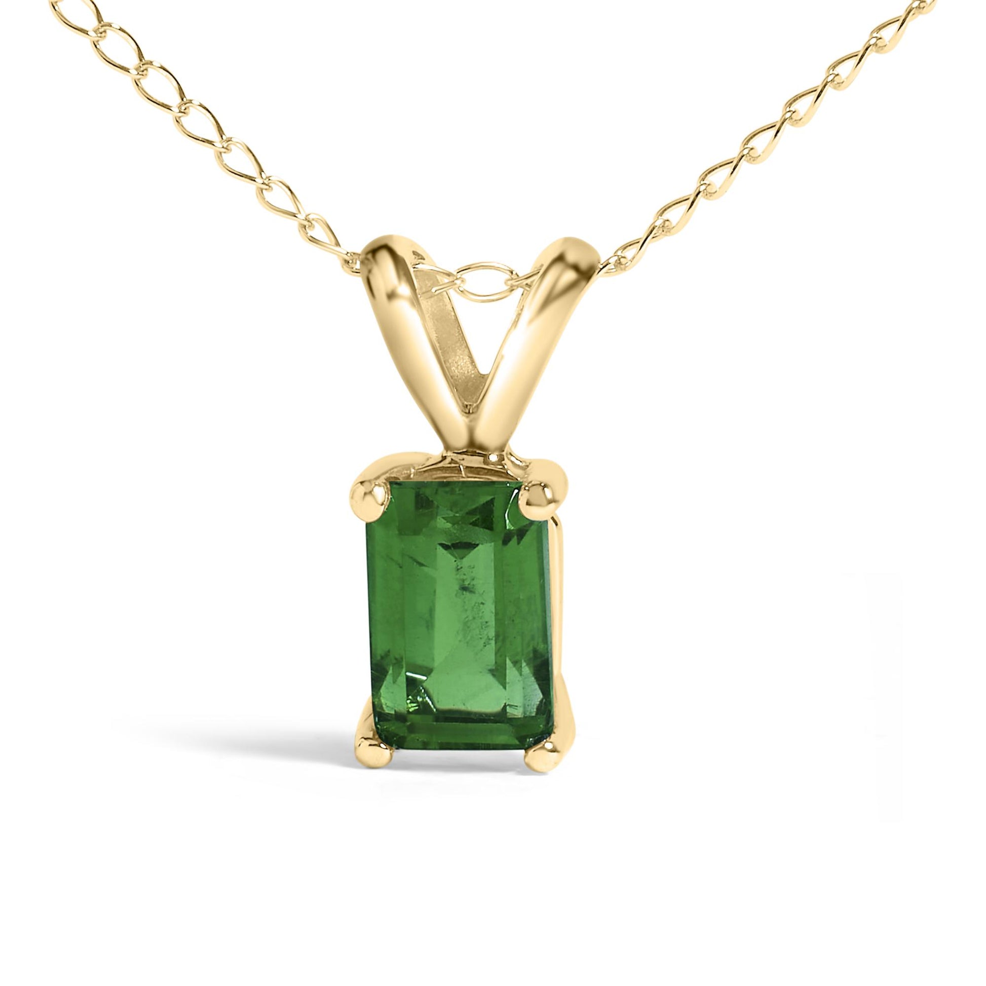Close-up front view of a yellow metal necklace featuring a rectangular green gemstone in a four-prong setting.