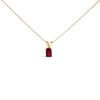 Yellow necklace with an emerald-shaped red gemstone pendant in a four-prong setting, shown from the front on a white background.