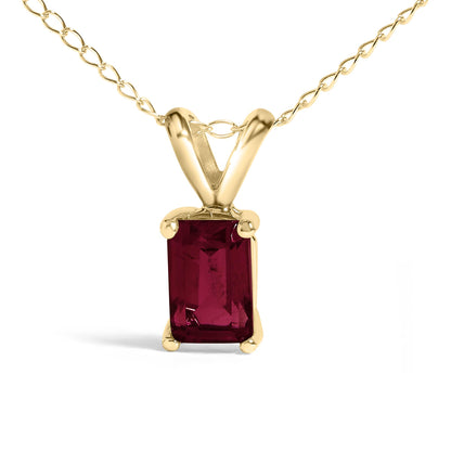 Close-up front angle of a yellow necklace featuring a rectangular red gemstone in a four-prong setting.