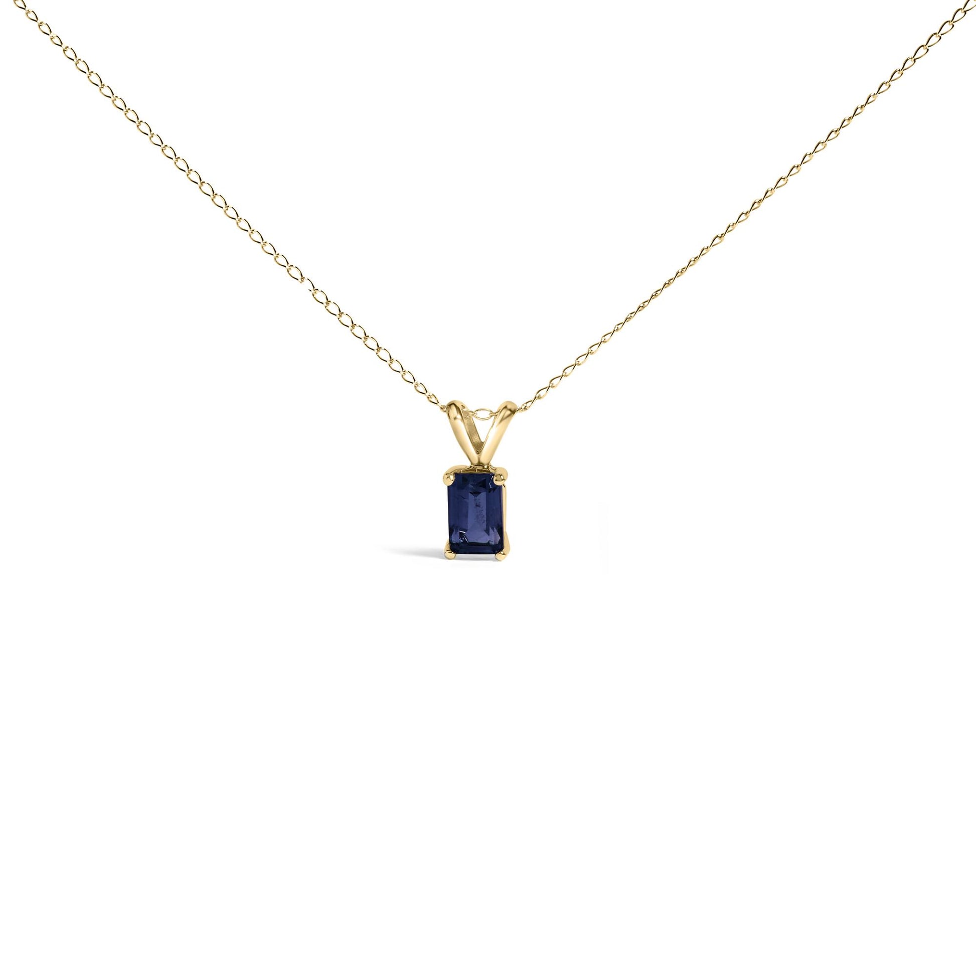 Yellow metal necklace with a rectangular blue gemstone pendant in a four-prong setting, shown in a centered front-facing angle on a white background.