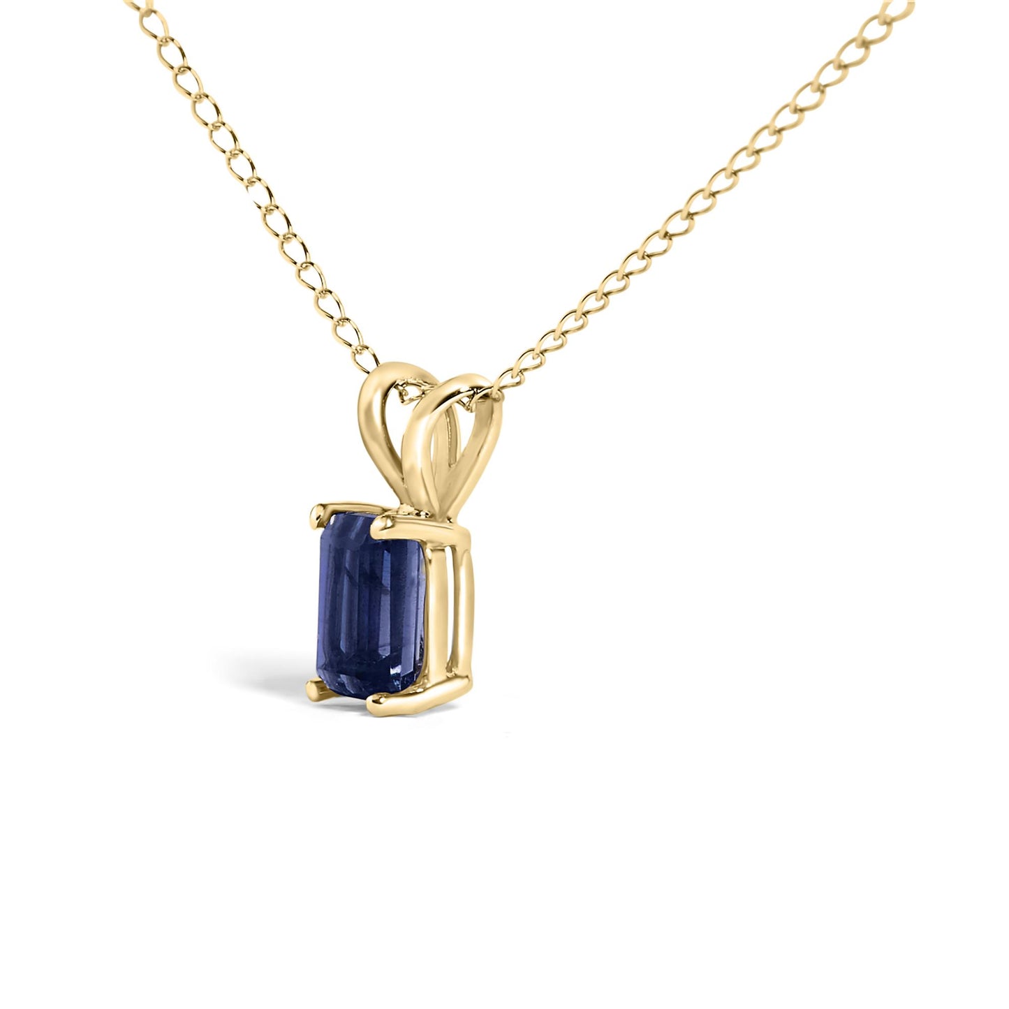 Close-up front angle of a yellow metal necklace with an emerald-cut blue gemstone pendant set in a four-prong setting.