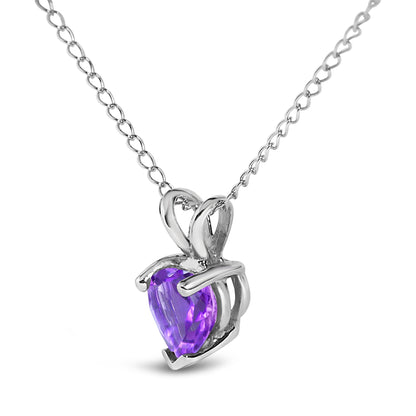 Close-up front angle of a white necklace featuring a heart-shaped purple gemstone pendant with a three-prong setting.