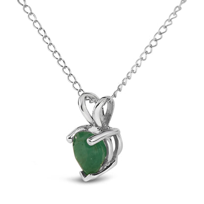 Close-up front angle of a white metal necklace featuring a heart-shaped green gemstone pendant in a three-prong setting.