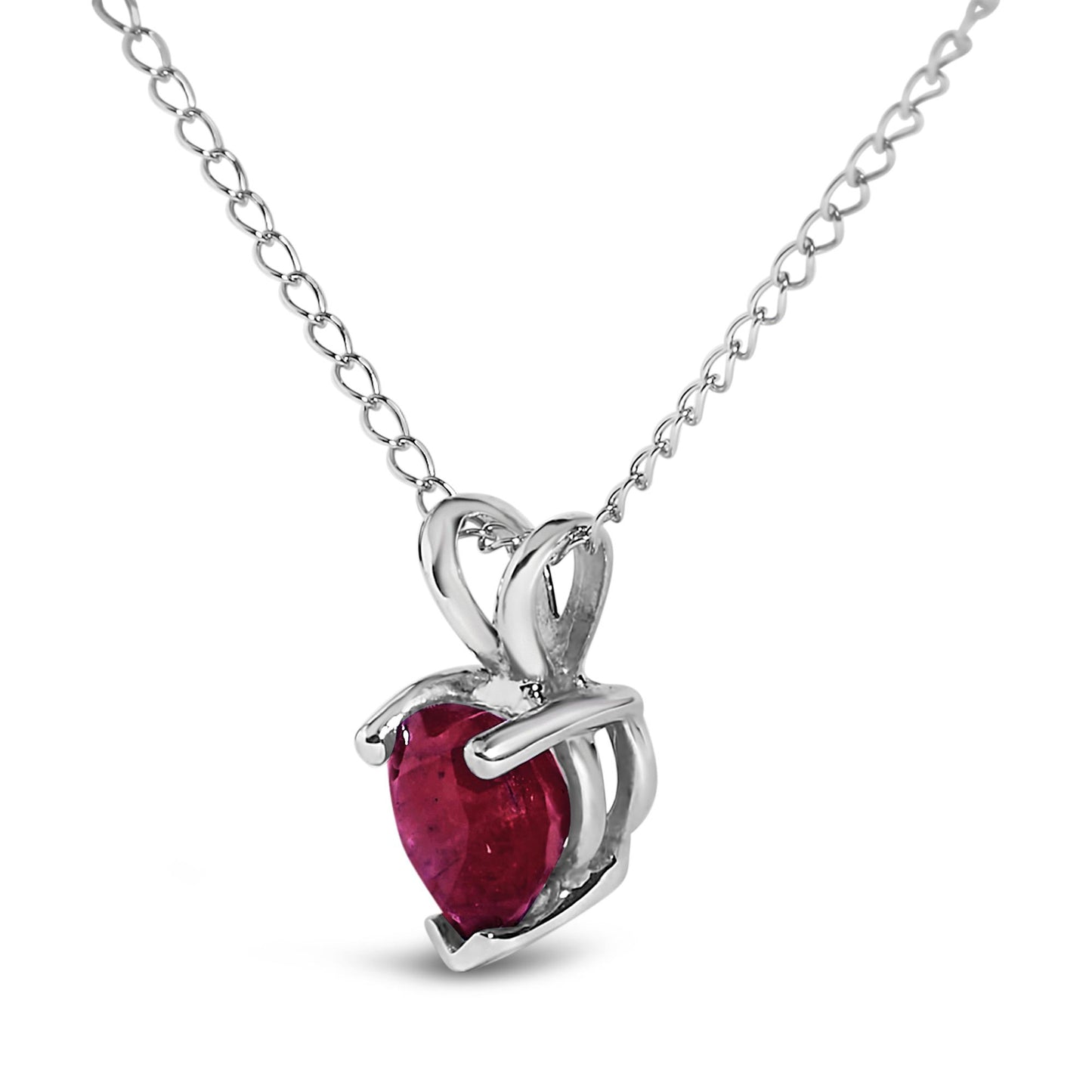 Close-up front view of a white metal necklace featuring a heart-shaped red gemstone pendant with a three-prong setting.